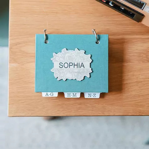 address book with alphabetical tabs in teal linen book cloth with personalized leatherette laser engraved with name.