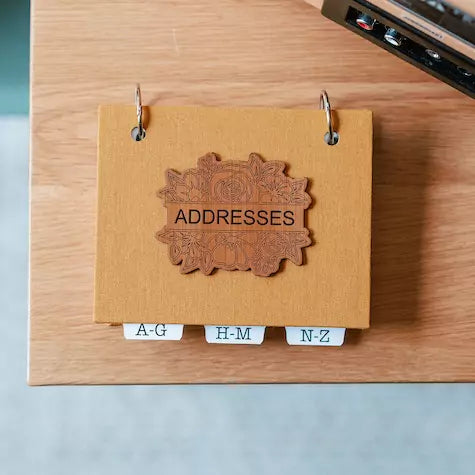 hardcover address book in mustard yellow linen book cloth and laser engraved title.