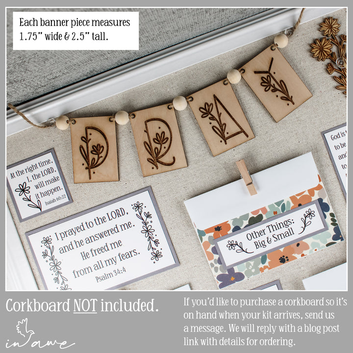Decorative pray banner pieces with floral daisy designs and text on prayer board.