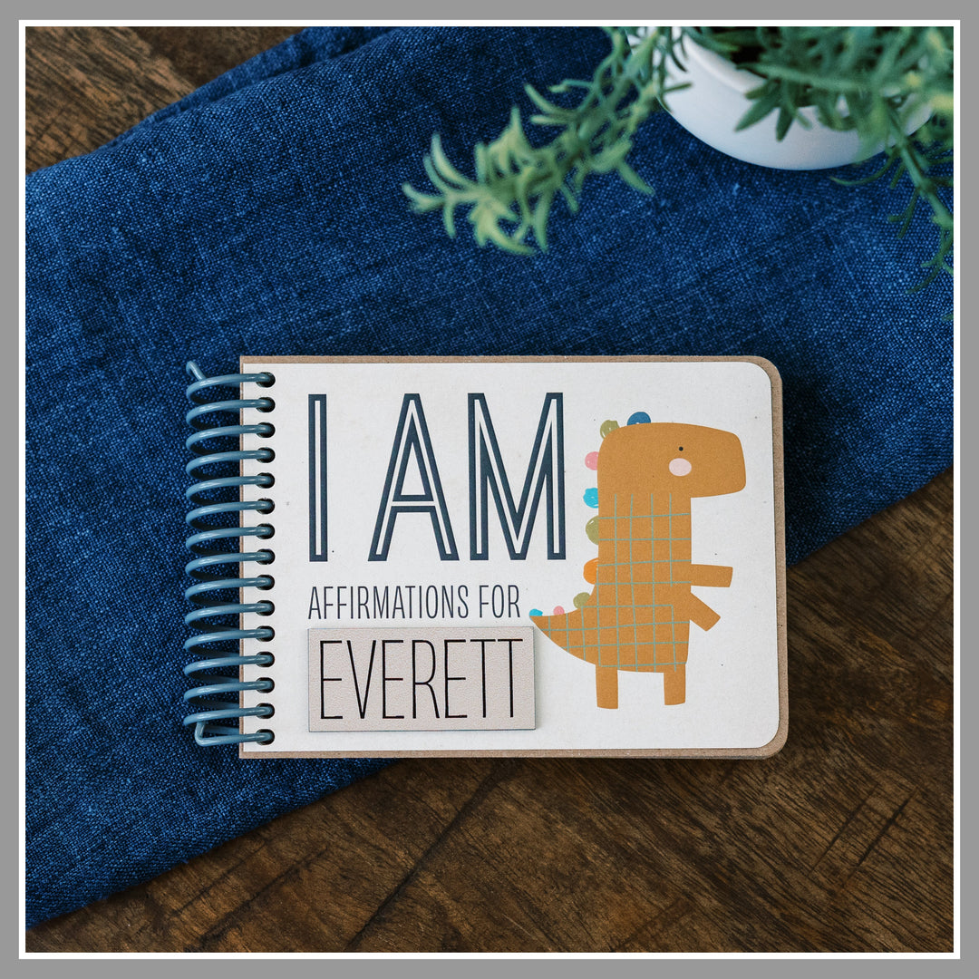Personalized Dinosaur affirmation book for kids with laser-engraved nameplate reading Everett.