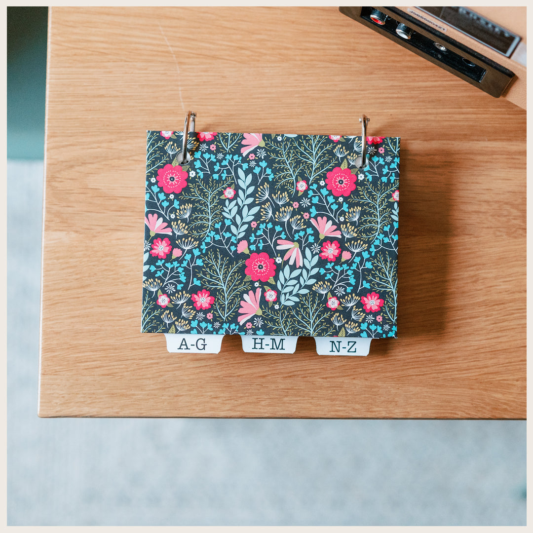 Dark Floral hardcover address book with a blank cover, two metal rings, and alphabetical tabs.