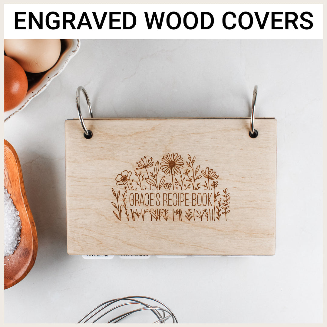 Baltic birch wood recipe binder engraved with wildflowers and personalized with “Grace’s Recipe Book.”
