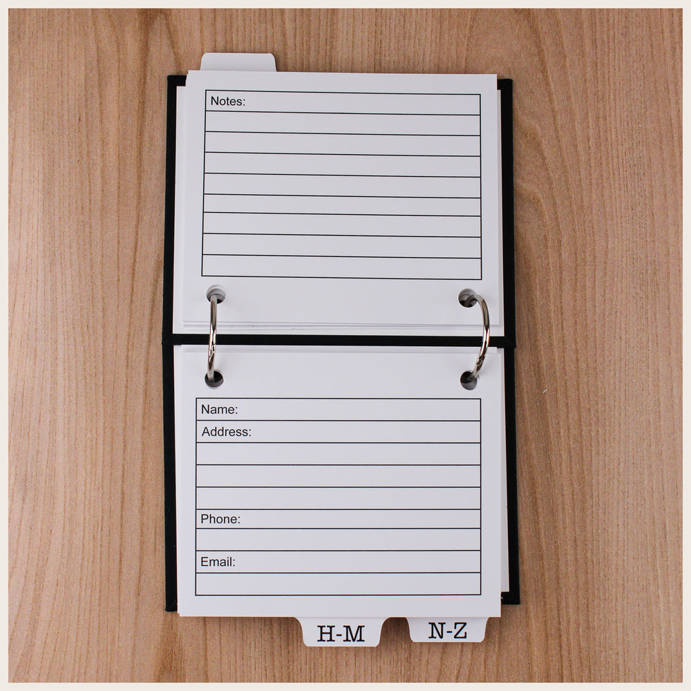 Open address book showing contact cards with fields for name, address, phone, and email, plus lined notes on the back.