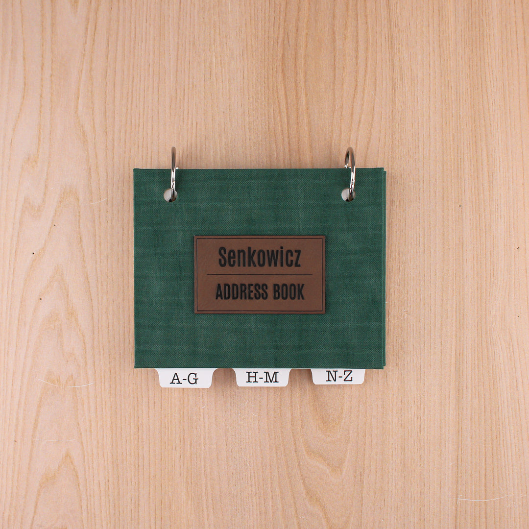 Dark green small address book with dark brown leatherette title "Senkowicz ADDRESS BOOK".