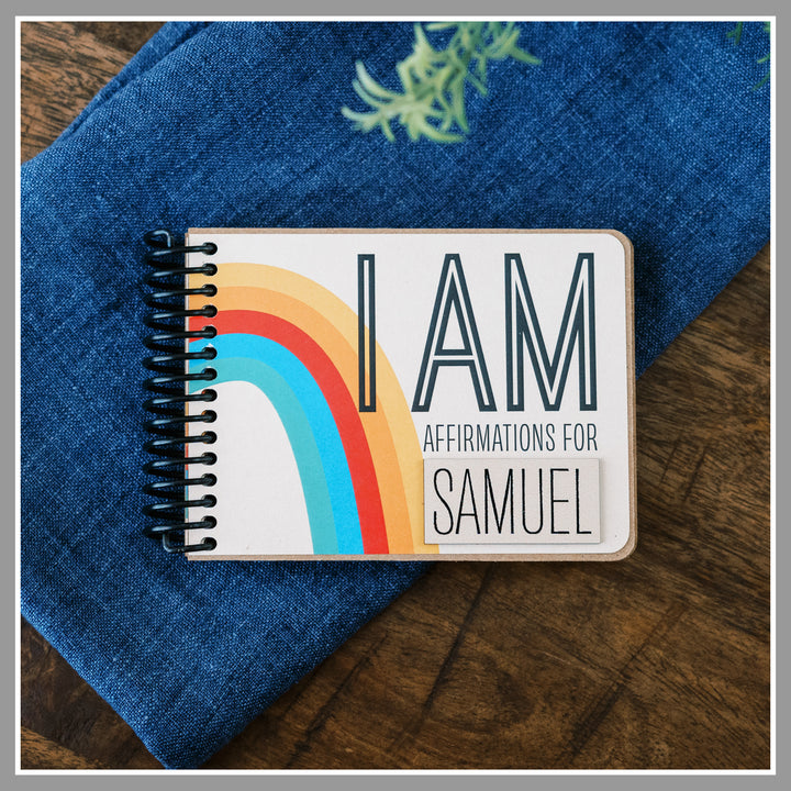 Rainbow book of positive affirmations for kids with ivory background and retro rainbow graphics in primary colors.
