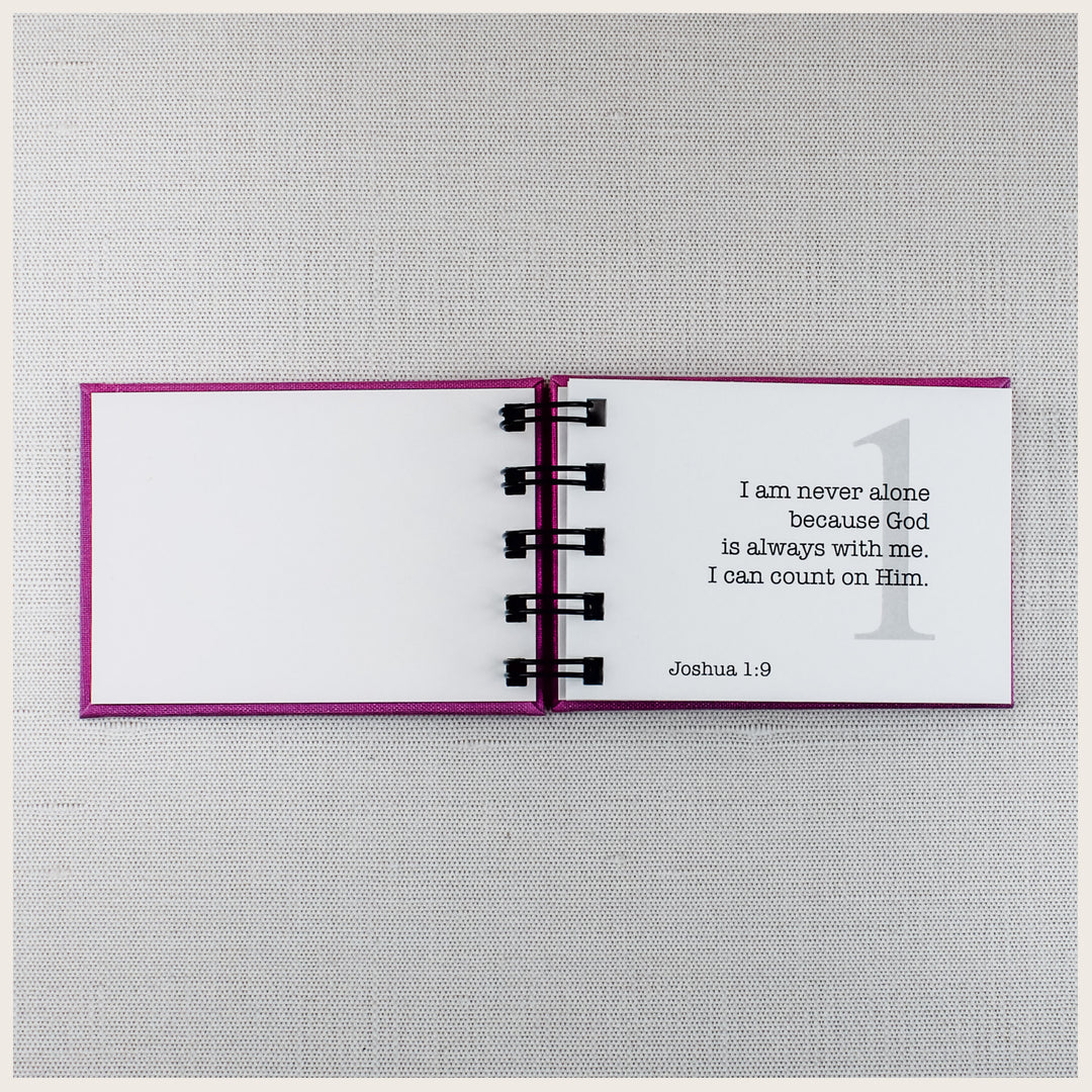 Open Christian affirmation book showing affirmation 1 about God always being with me, with the Scripture reference Joshua 1:9.