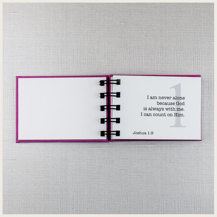 Open Christian affirmation book showing affirmation 1 about God always being with me, with the Scripture reference Joshua 1:9.