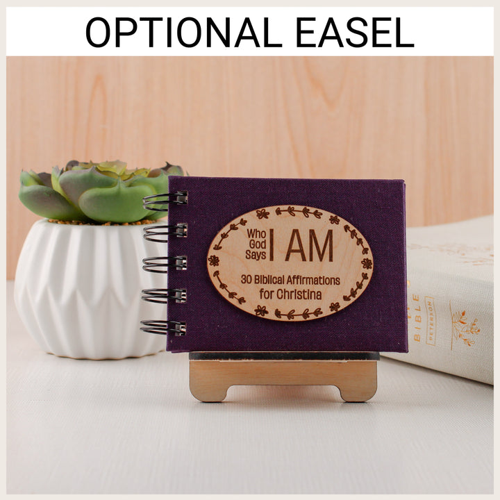 Plum affirmation book personalized for Christina displayed on an optional wood easel beside a succulent and Bible.