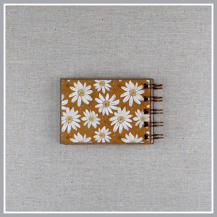 Back cover of small spiral bound attributes of God book in Daisy style with yellow background and ivory flowers. Front cover says "this is our GOD".