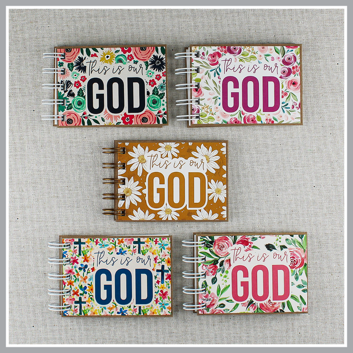 Five small spiral-bound books filled with God's attributes with floral covers and text that says "this is our GOD".