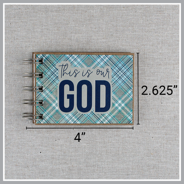 Dimensions of spiral-bound book with 'This is our God' text on a plaid blue and gray cover. It is 4" wide and 2.625" tall.