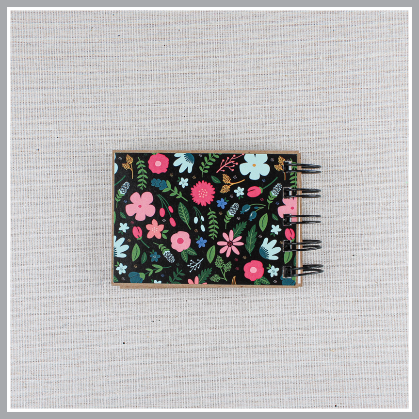 Back cover of God's attributes book with black background and pastel florals. Text says 'this is our GOD'.