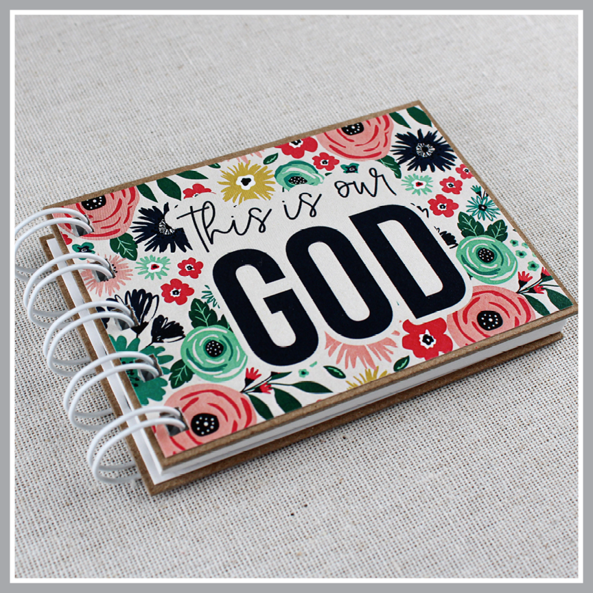 Attributes of God book in Blue Floral design and 'This is our God' text on a light gray background.