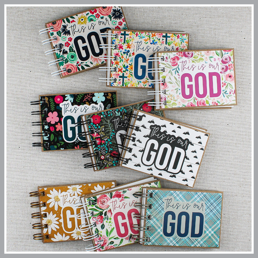 Collection of books with 30 attributes of God with colorful designs and 'This is our GOD' text on a textured surface.