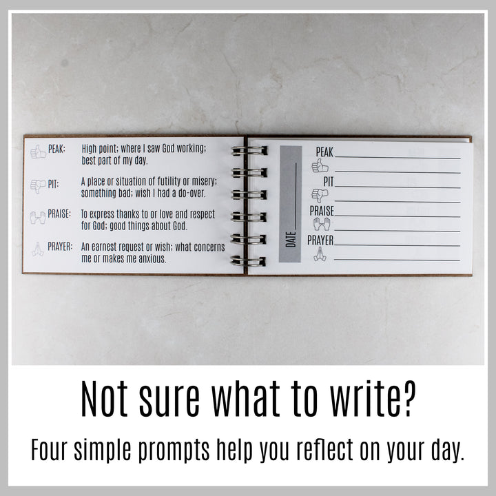 Open guided prayer journal with four simple prompts to help with daily Christian reflection and prayer.