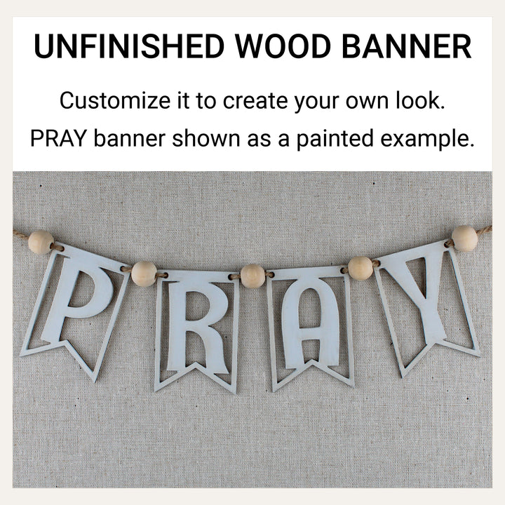 White-painted wooden PRAY banner demonstrating how unfinished wood banner pieces can be customized.
