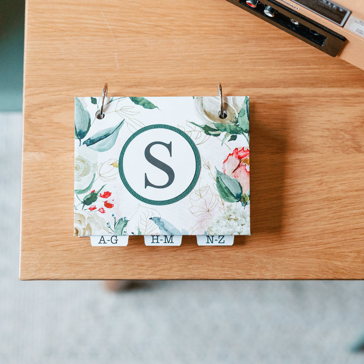 Floral desk organizer with S initial on front cover.