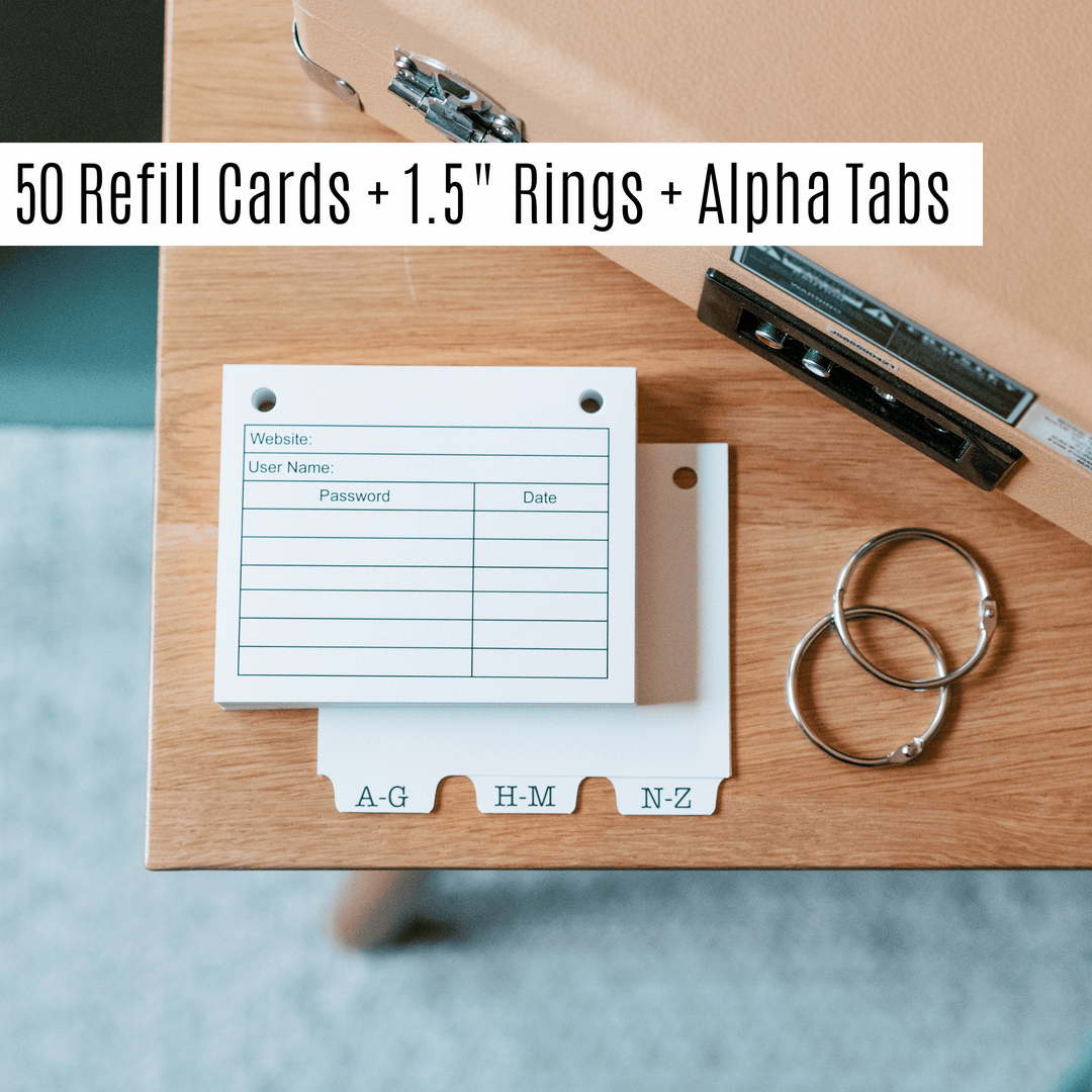password book refill pages, alpha tabs and 1.5" book rings on wood surface.
