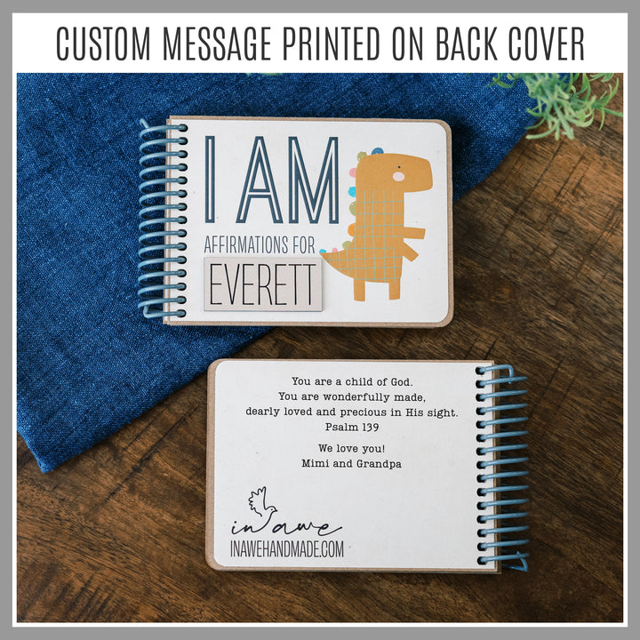 Personalized Dinosaur affirmation book with laser-engraved nameplate and custom message printed on the back.
