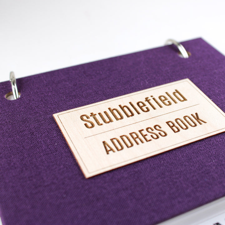 Close up of personalized front cover title on maple wood veneer.