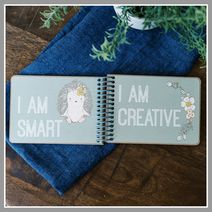 Open Green Floral affirmation book showing “I am smart” and “I am creative” pages with sage green background and graphics of animals and florals.