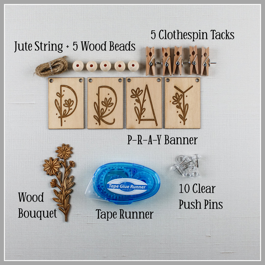 Prayer board diy kit contains jute string, wood beads, banner, clothespin tacks, wood bouquet, tape runner and push pins.
