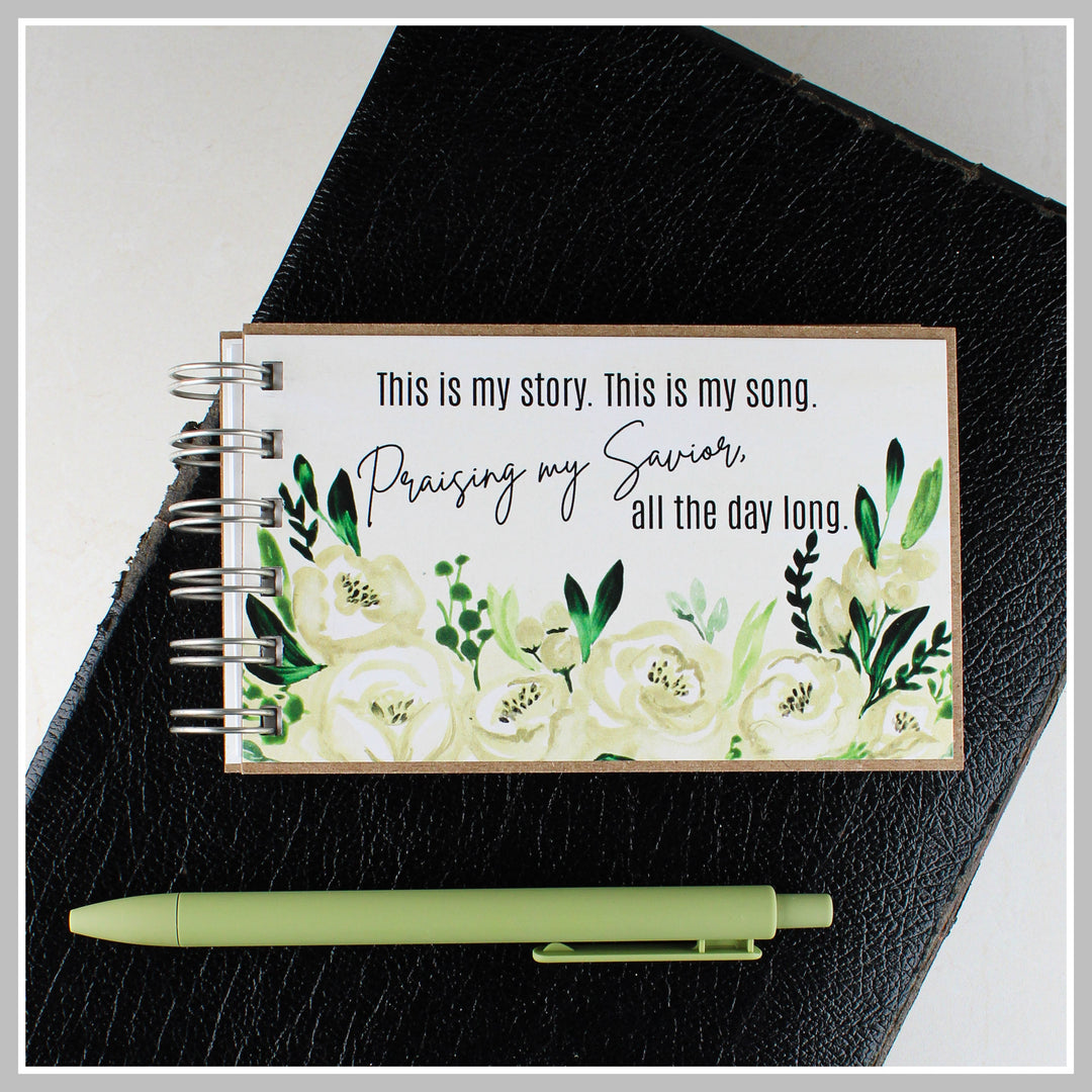 Botanical Christian journal resting on a Bible for prayer, gratitude and daily quiet time.
