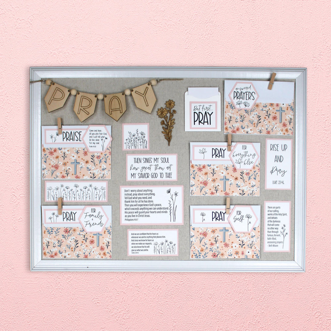 Prayer boards are an excellent prayer room decor idea. Pictured here in the wildflower style with blush pink mats and wildflower cross envelope covers.