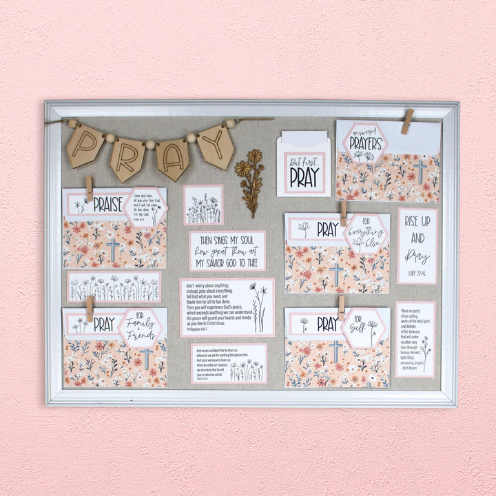 Prayer boards are an excellent prayer room decor idea. Pictured here in the wildflower style with blush pink mats and wildflower cross envelope covers.