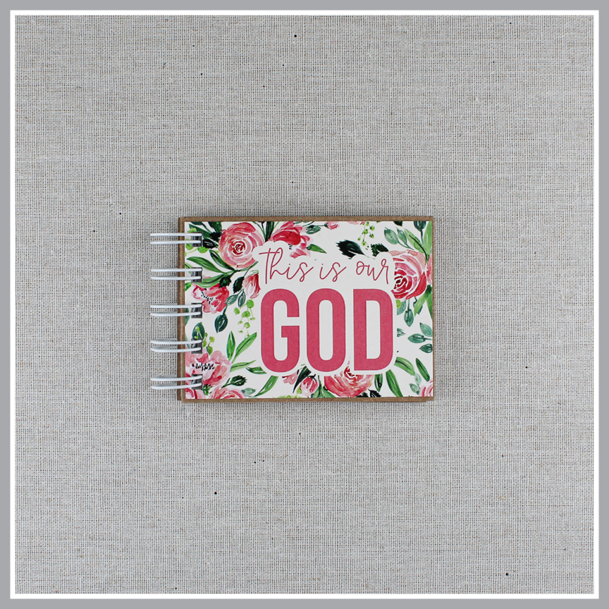 Attributes of God spiral bound book with pink flowers and green leaves. Front cover says "this is our GOD".