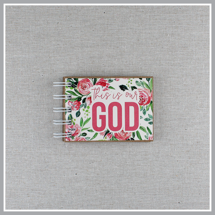 Attributes of God spiral bound book with pink flowers and green leaves. Front cover says "this is our GOD".