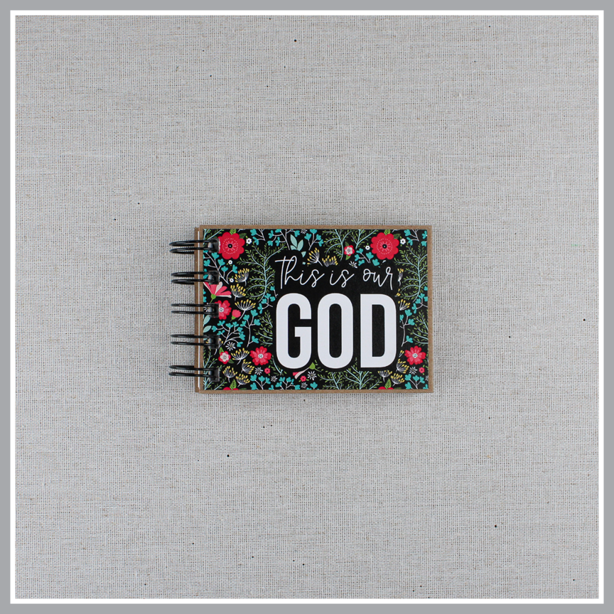 God's attribute book with a black background and bright florals. The cover of this small, spiral-bound book says "this is our GOD".