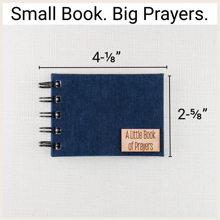 Navy spiral prayer book with size labels showing 4⅛ inches wide, including binding, and 2⅝ inches tall.