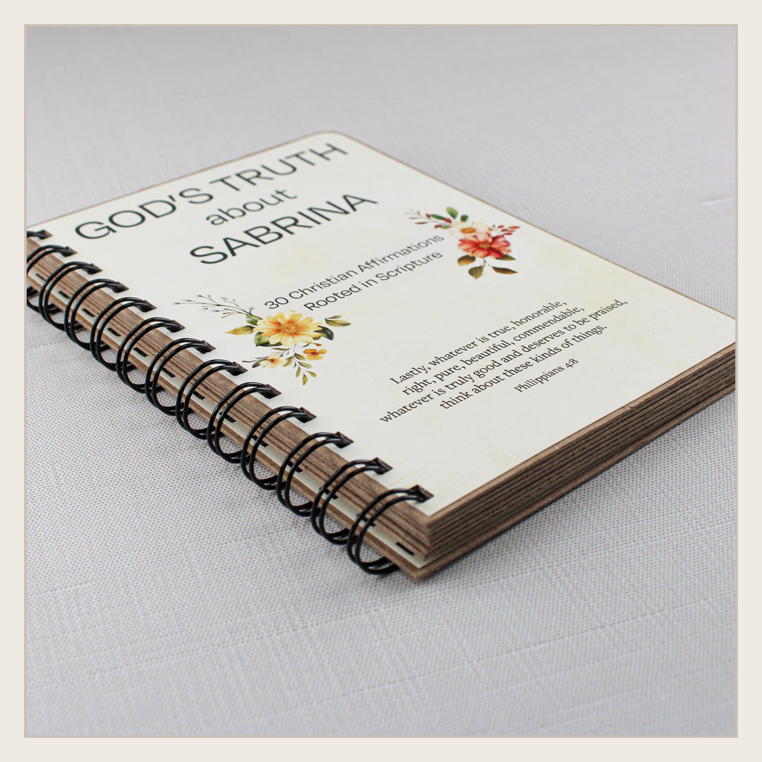 Angled view of personalized spiral-bound Christian affirmation book showing its sturdy pages and construction.