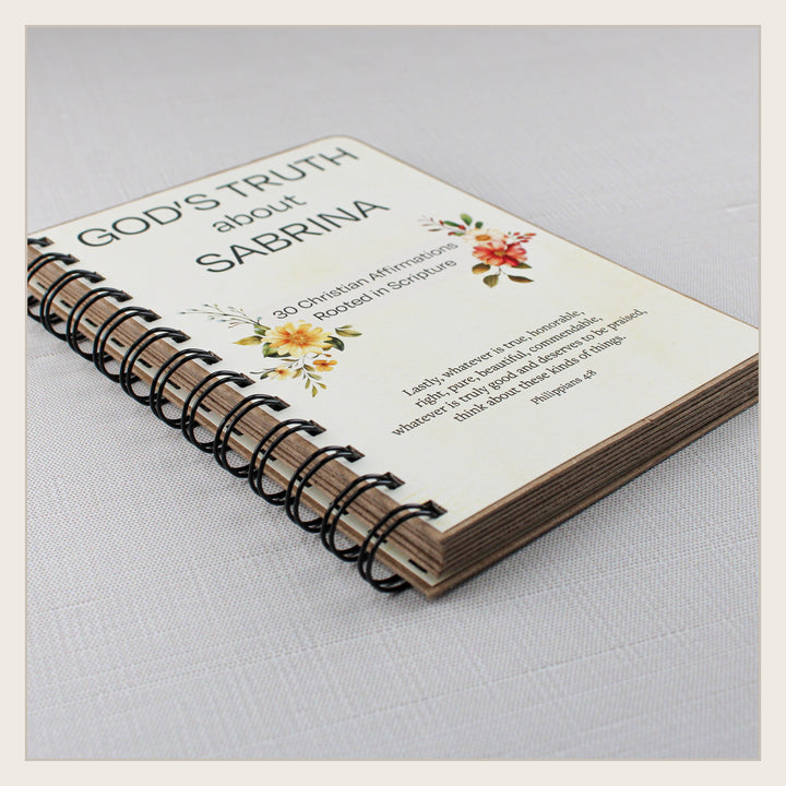 Angled view of personalized spiral-bound Christian affirmation book showing its sturdy pages and construction.