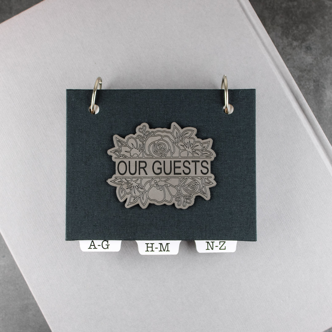 address book with charcoal gray linen book cloth and gray leatherette with a split floral design that says OUR GUESTS.