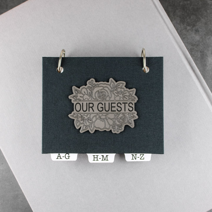 address book with charcoal gray linen book cloth and gray leatherette with a split floral design that says OUR GUESTS.