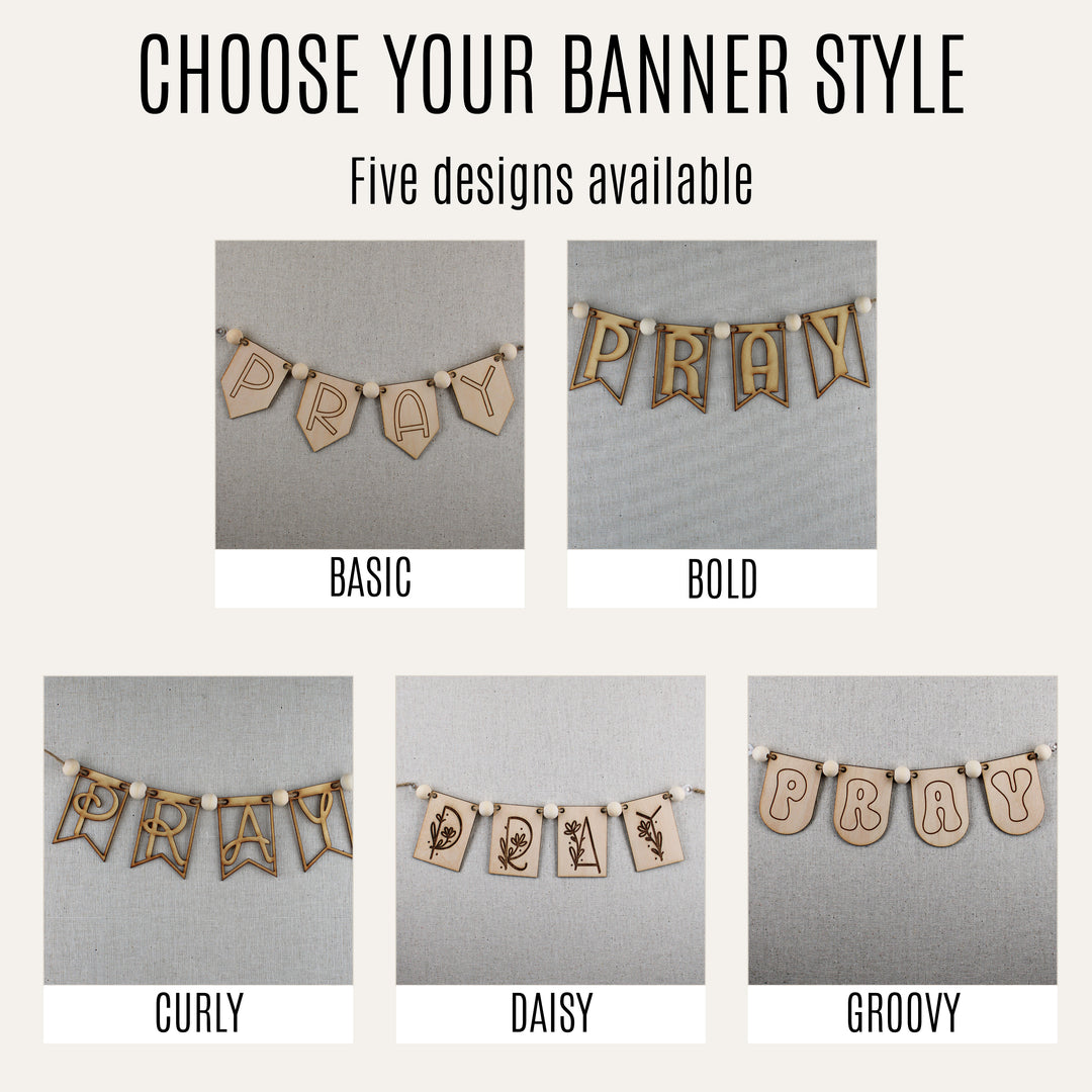 Five wooden PRAY banner styles—Basic, Bold, Curly, Daisy and Groovy—displayed on neutral fabric.