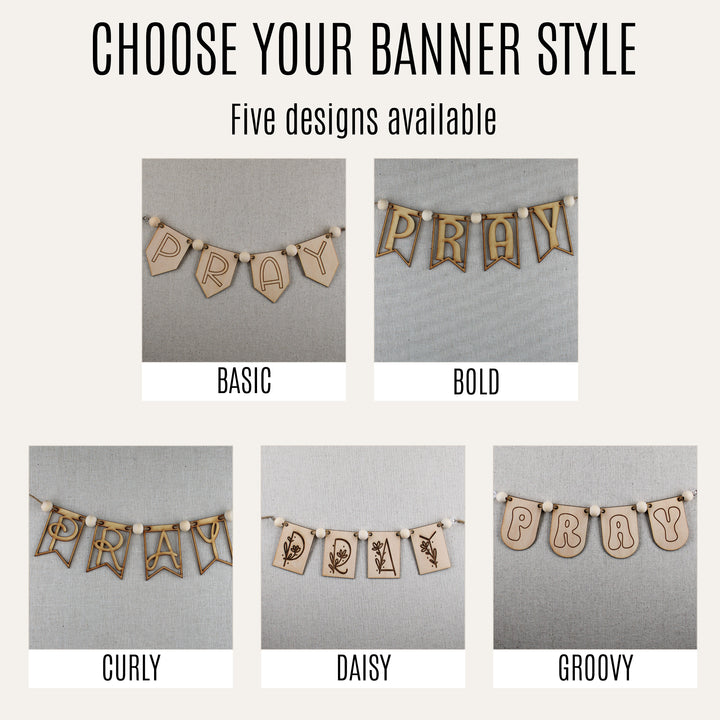 Five wooden PRAY banner styles—Basic, Bold, Curly, Daisy and Groovy—displayed on neutral fabric.